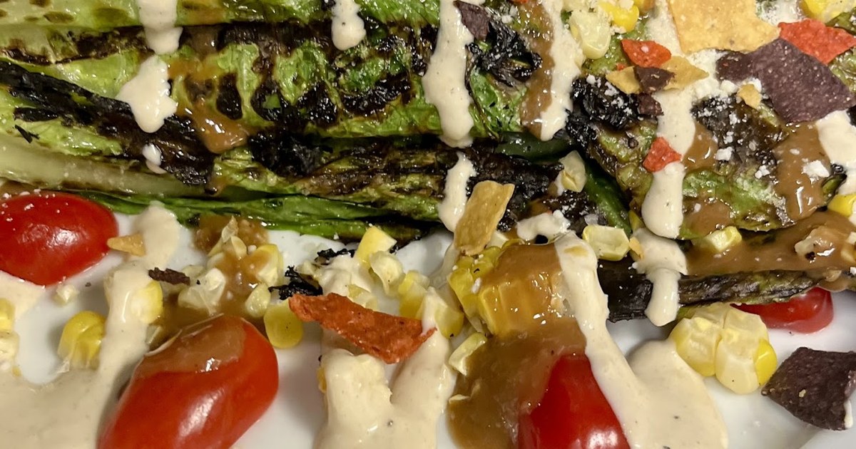 The grilled romaine salad with corn, tomatoes and tortilla strips at Amici Tavern in North Haven