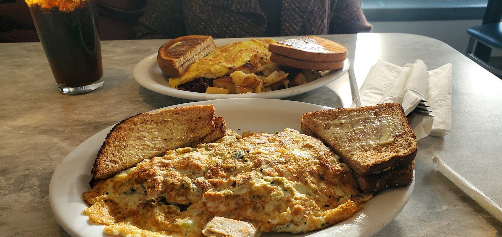 An omelette with toast and home fries at the Athena II Diner