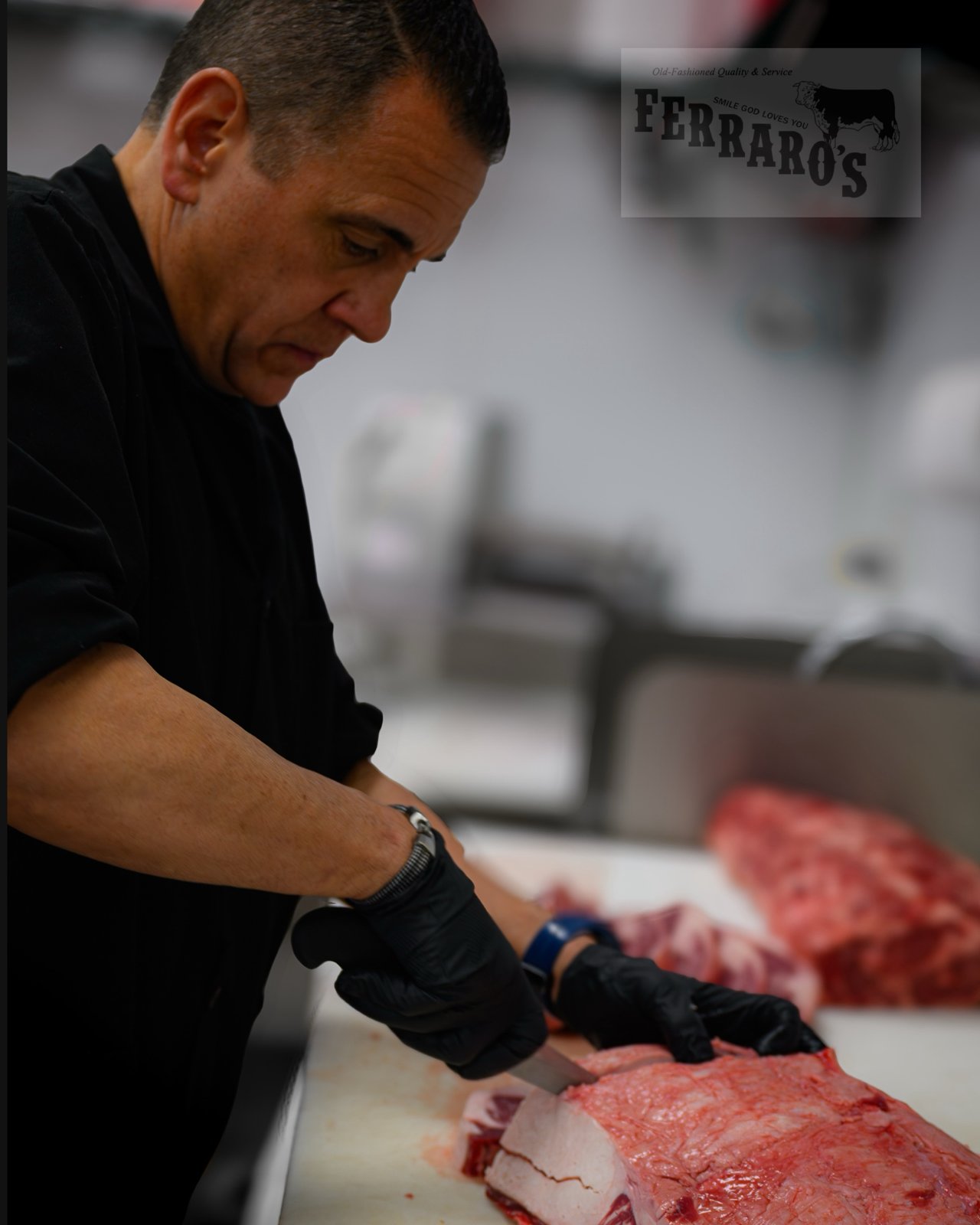 A butcher at work at Ferraro’s Market on Universal Drive in North Haven
