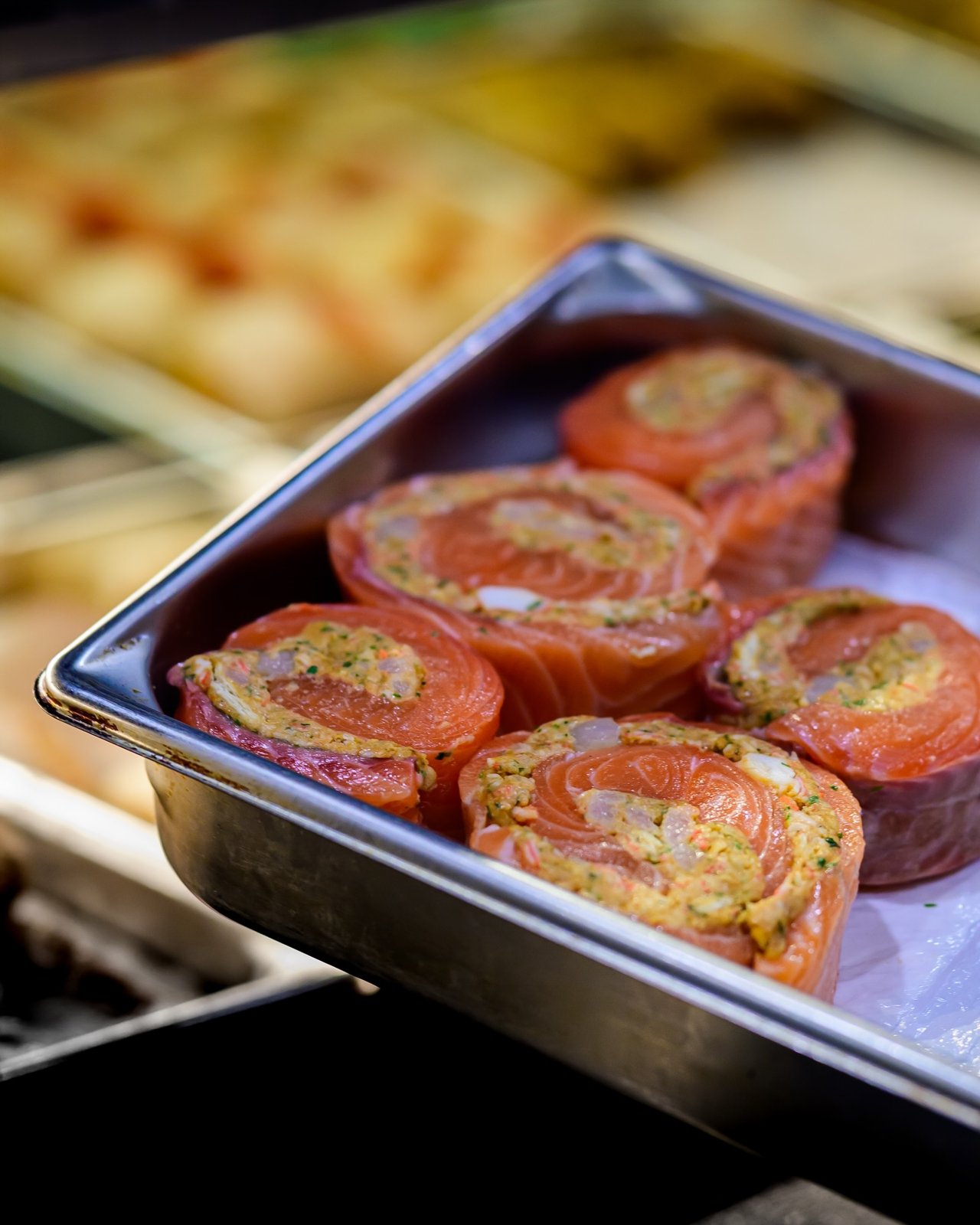 Stuffed salmon pinwheels in the seafood case at Ferraro’s Market