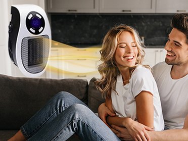 GoGo Heater plug-in heater with a couple relaxing on a sofa