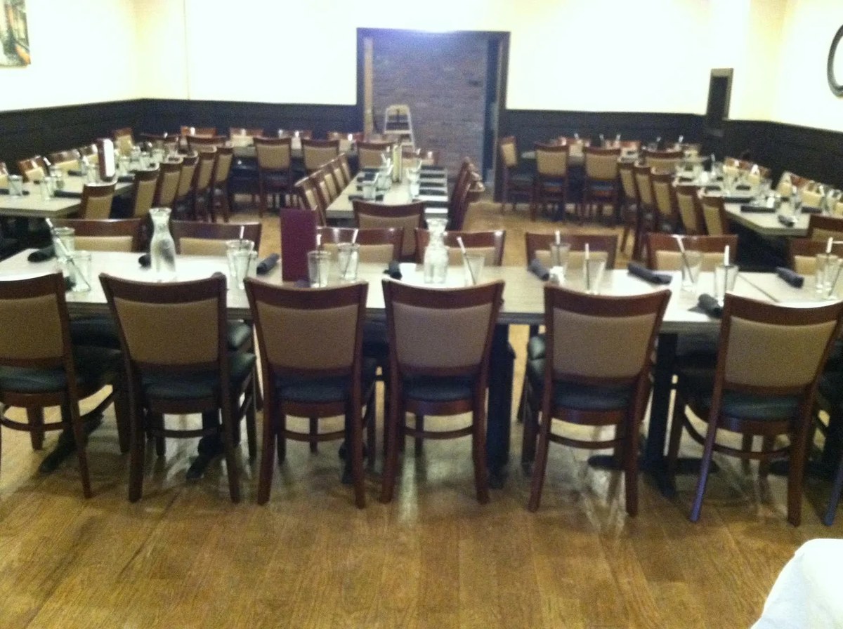 Long tables set with chairs in the J Roo’s group dining room in North Haven