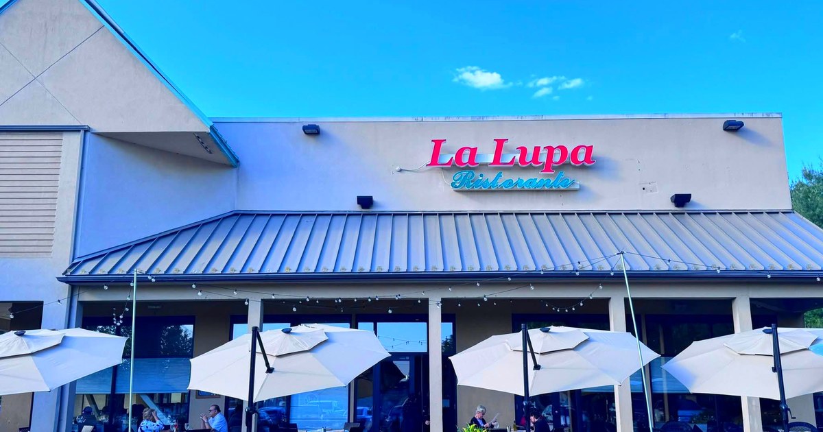 The La Lupa Ristorante sign and patio umbrellas at 344 Washington Ave. in North Haven