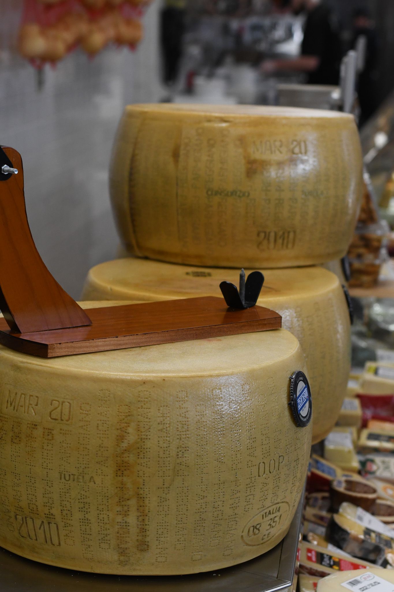 Wheels of aged cheese on display at Liuzzi Gourmet Food Market