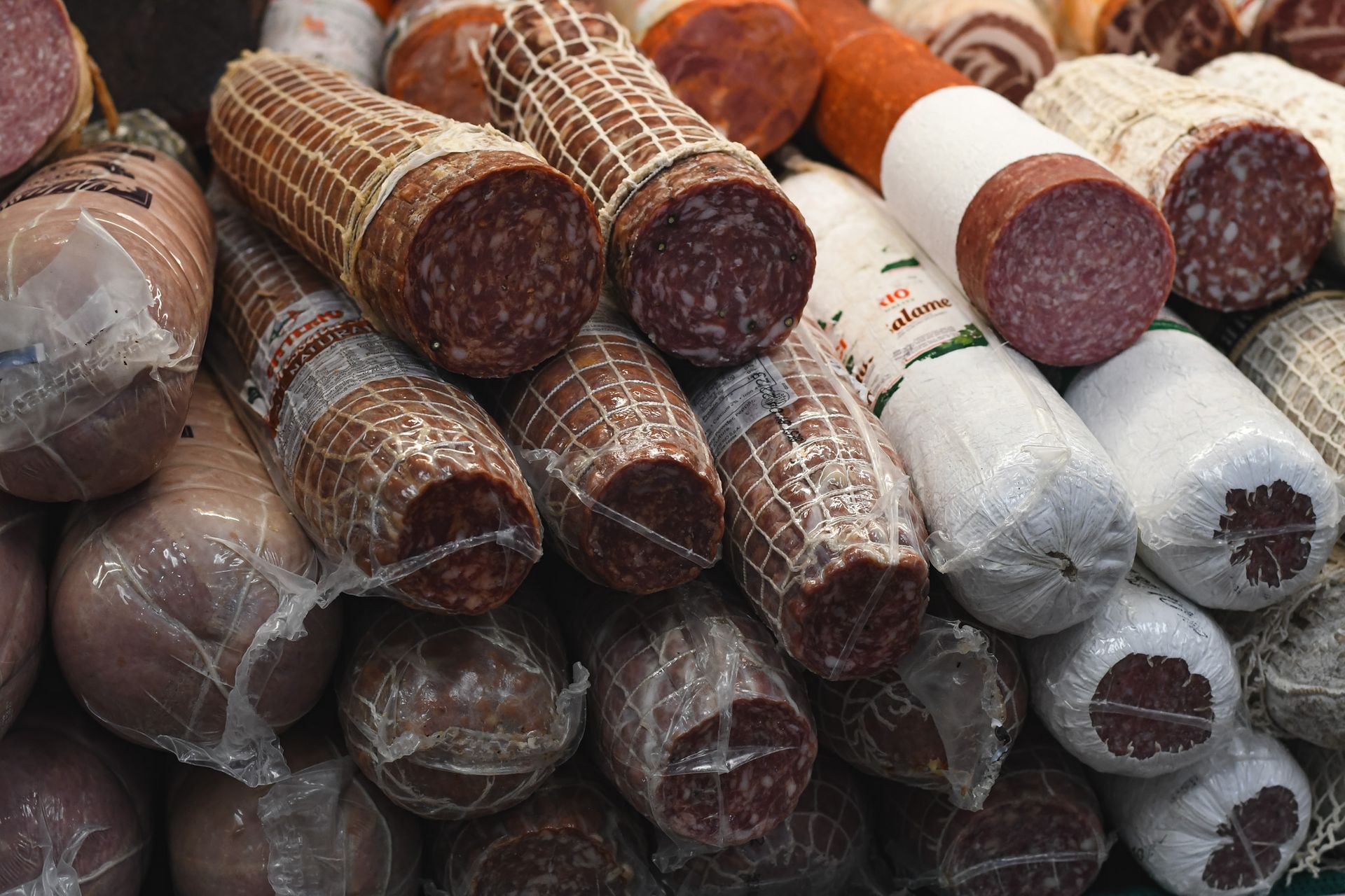 Imported salumi stacked in the case at Liuzzi Gourmet Food Market