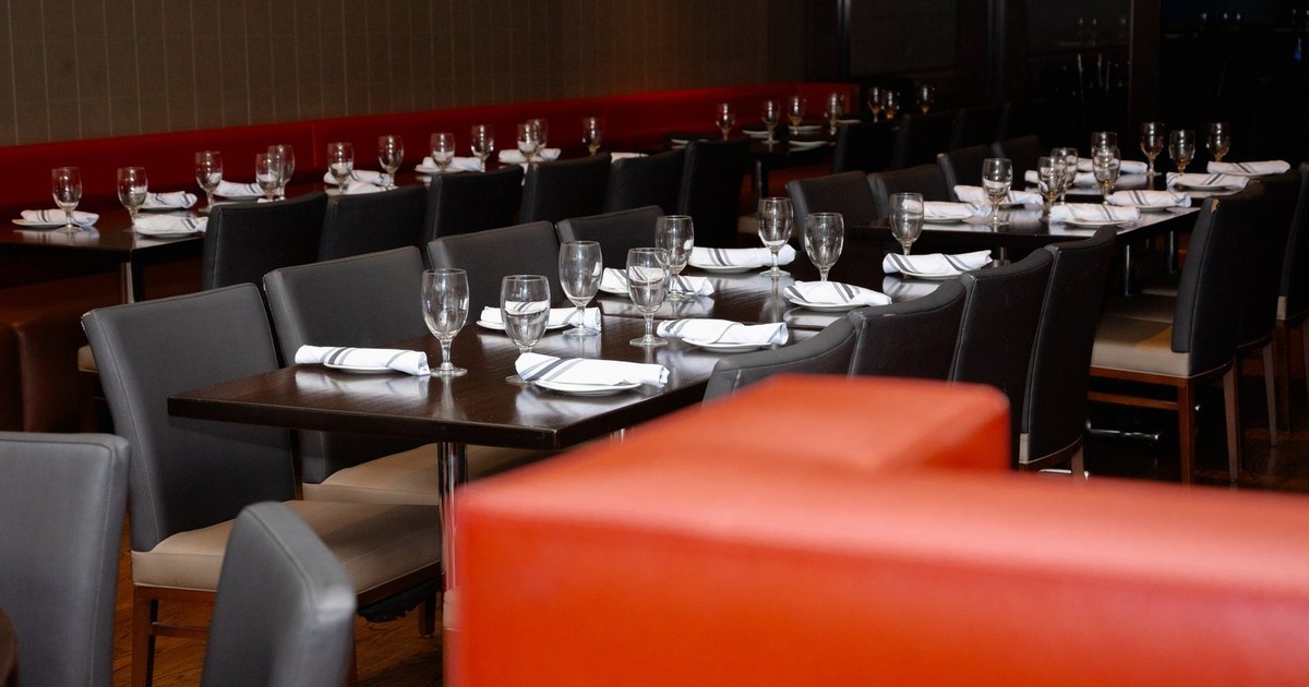 The dining room at Ludal’s Italian Restaurant in North Haven, with tables set and red banquettes