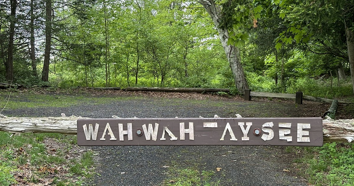 The Wah Wah Taysee sign on a log rail at the entrance to the former Scout camp, now North Haven Land Trust property