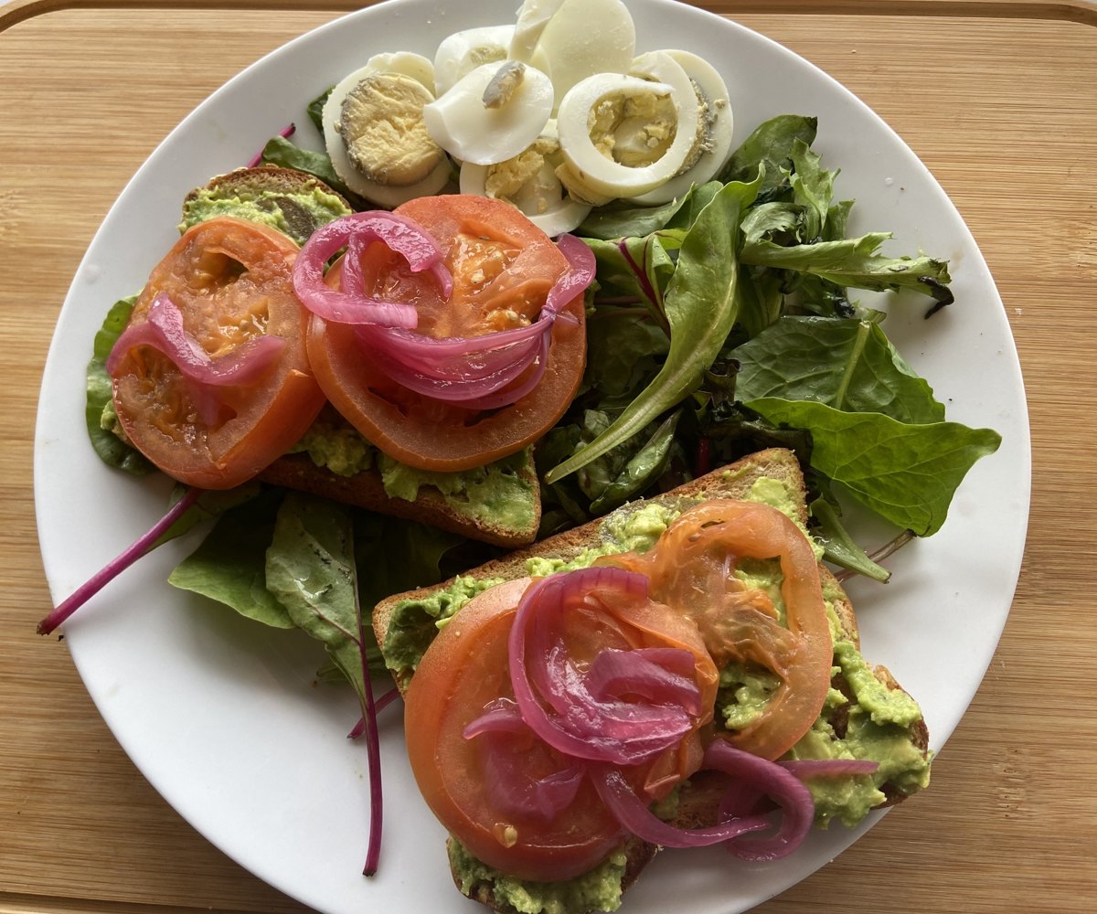 Avocado Crush on You toast with grilled tomatoes and pickled red onions at Sam's Place