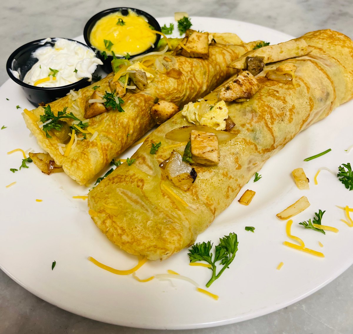 The Chickichanga savory crêpe at Sam's Place with chicken, eggs and cheese, served with hollandaise