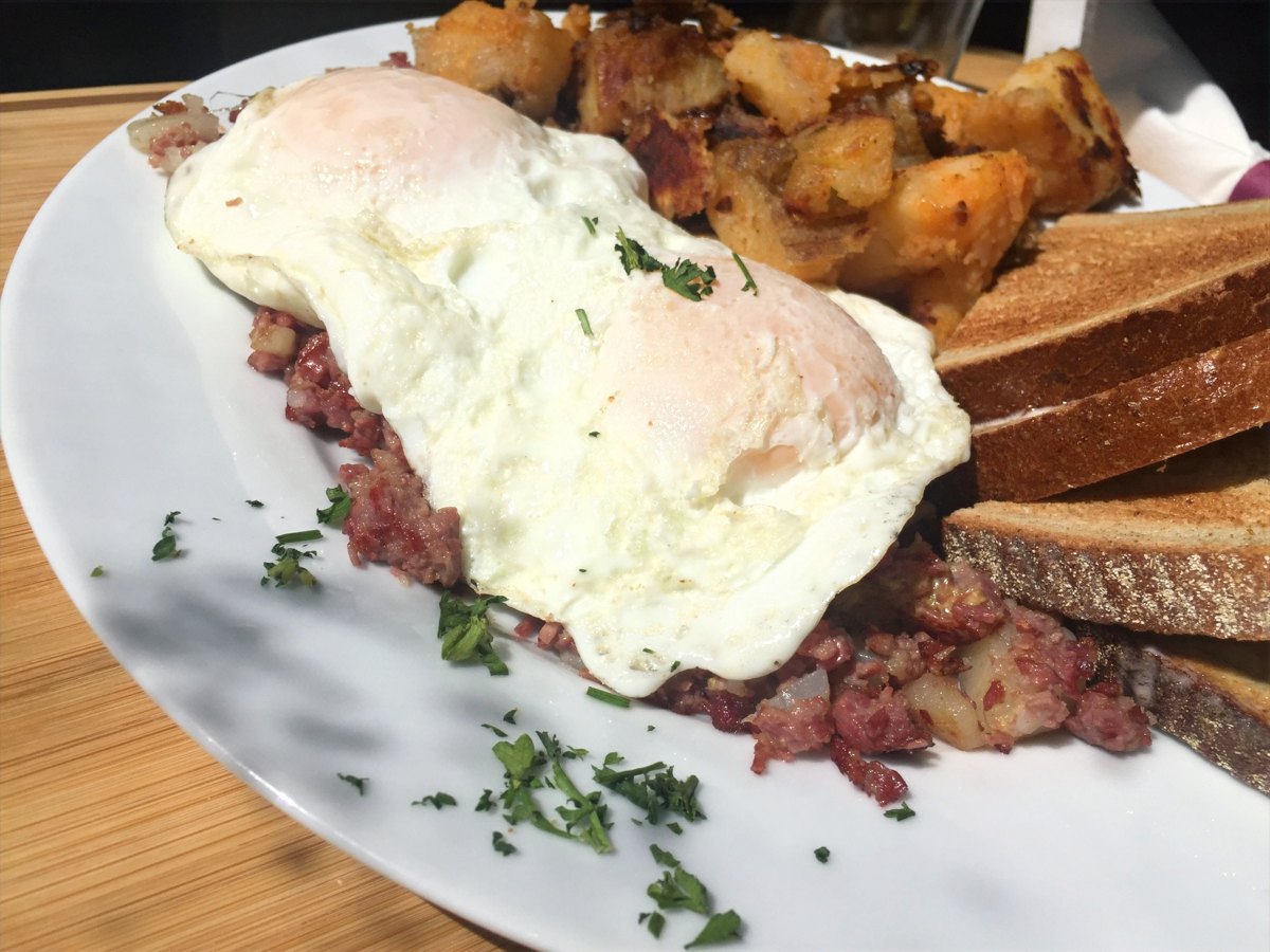 House-made corned beef hash topped with two fried eggs, with home fries and toast, at Sam's Place