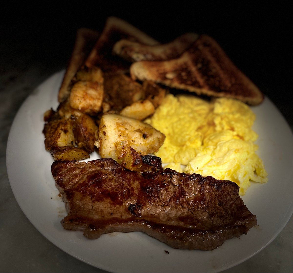 Sam's Steak and Eggs with sirloin, scrambled eggs, home fries and toast