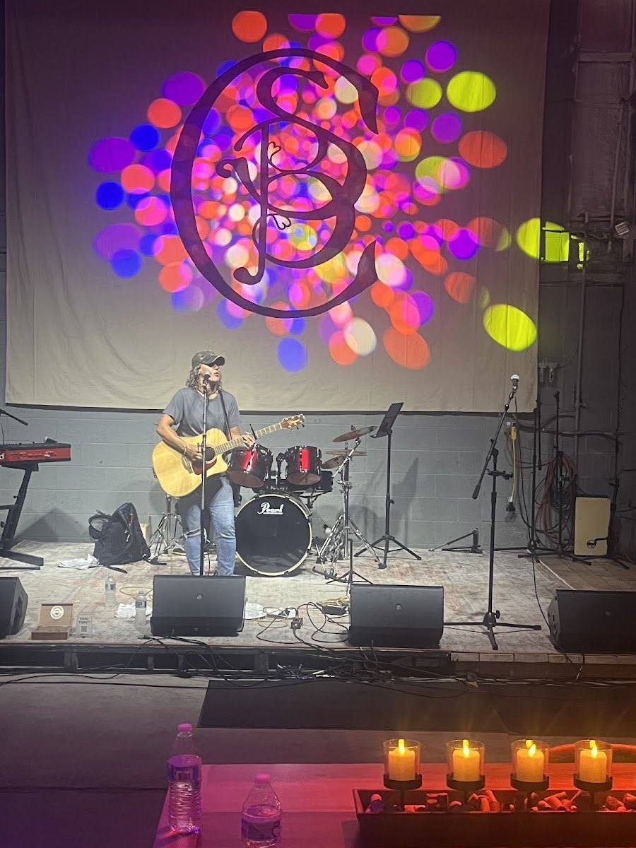 A musician performs on the indoor stage at Small Batch Cellars