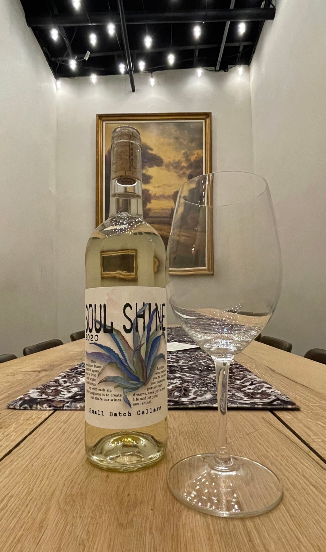 A bottle of Small Batch Cellars Soul Shine 2020 Sauvignon Blanc beside a wine glass