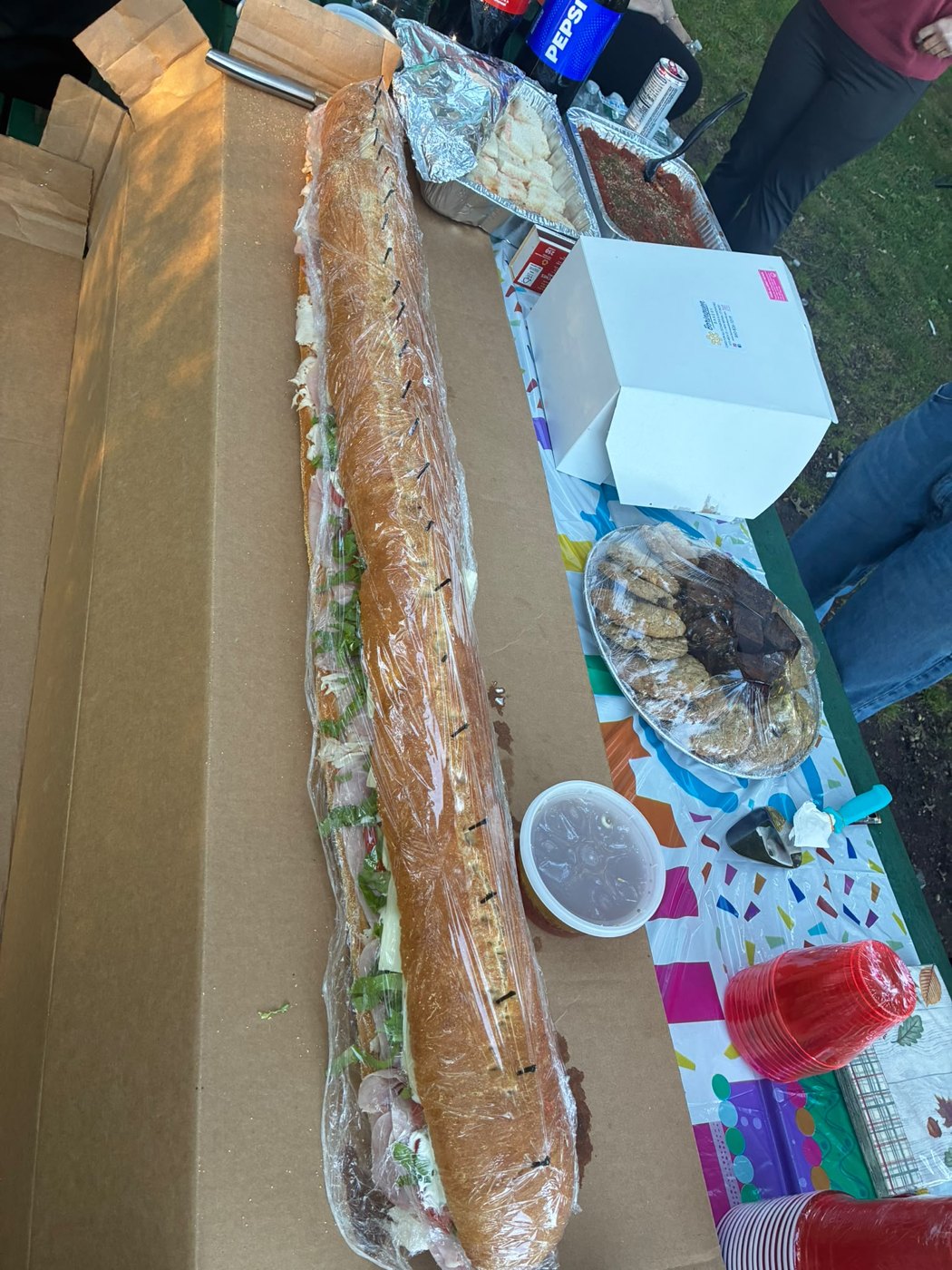 A giant party sub from Stellato’s Deli laid out on a table for a gathering