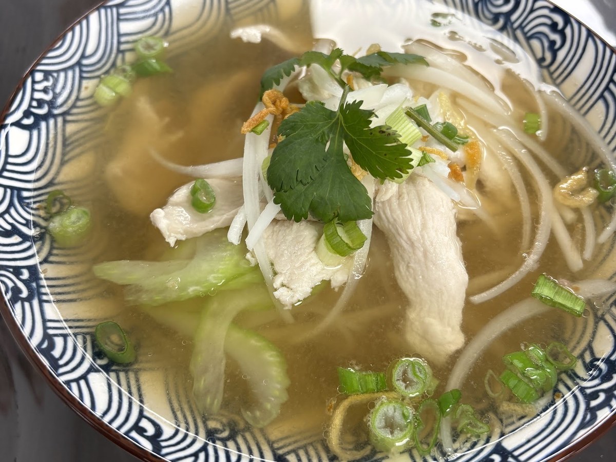 A bowl of chicken noodle soup with rice noodles, cilantro and scallions at Thai Yummy in North Haven