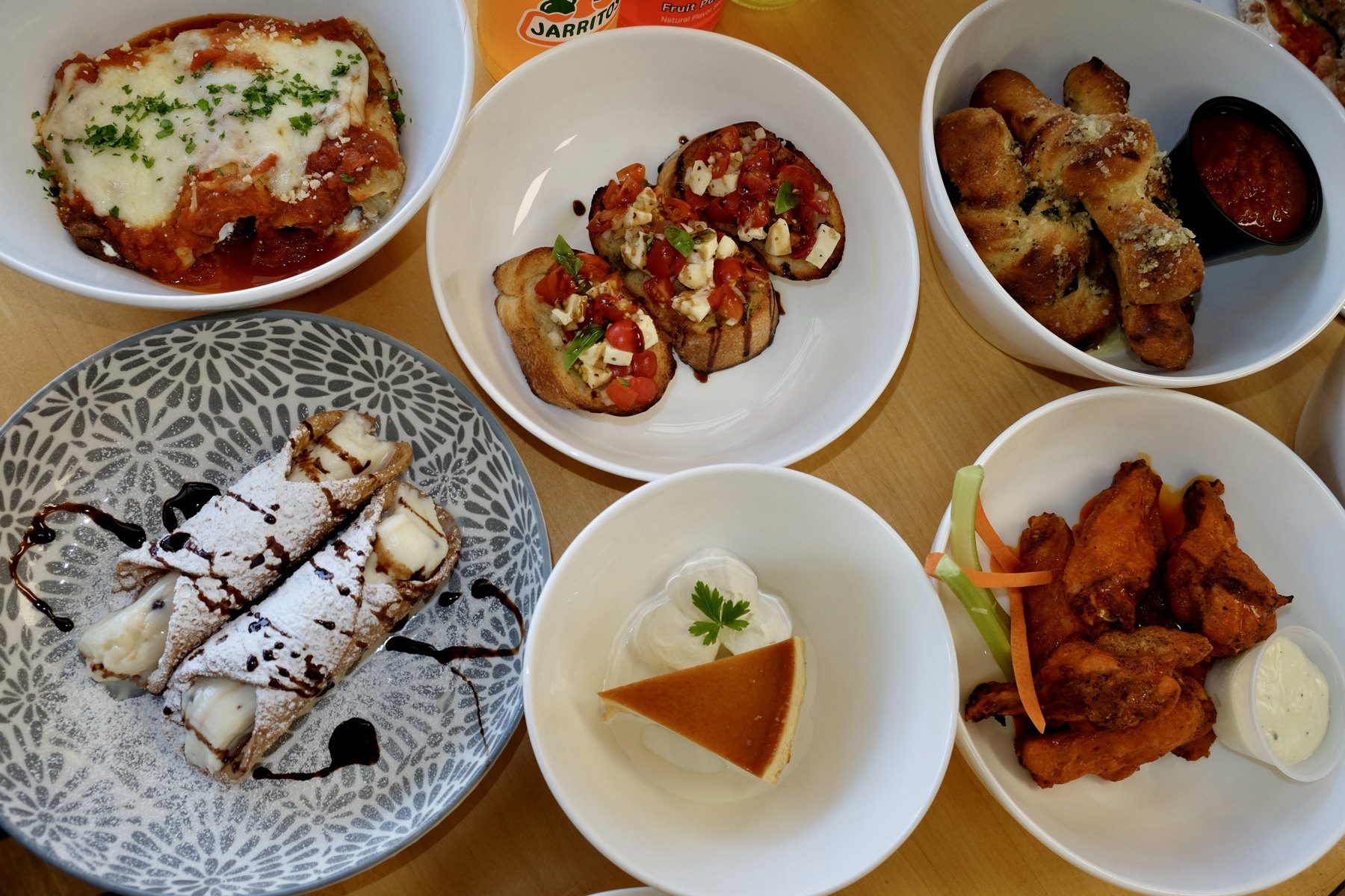Bruschetta, garlic knots, wings, cannoli and more on the table at Venezia Pizza