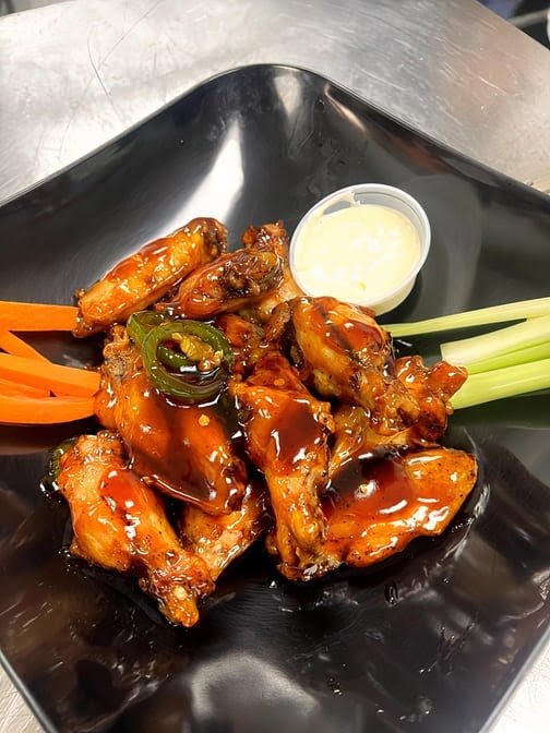 Glazed chicken wings with celery and carrots from Venezia Pizza