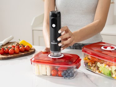 Wamoma handheld vacuum sealer on a food container